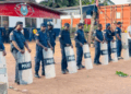 Liberia National Police officers in riot gear stand in formation after arresting six individuals linked to a protest in Ganta, Nimba County.