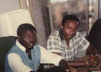 A young Mohamed Koneh (left) and journalist Omari Jackson (right) in the 1980s, discussing the move that would launch George Weah’s football career in Cameroon.