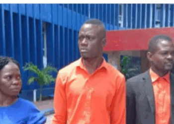 Liberia National Police present suspects accused of defrauding a businesswoman through a fake Canada travel program linked to QNET/Infinity Millennial Liberia