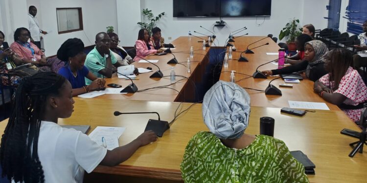Adolescent girls and women engage in an intergenerational dialogue at One UN House in Monrovia during Liberia’s International Day of the Girl Child event