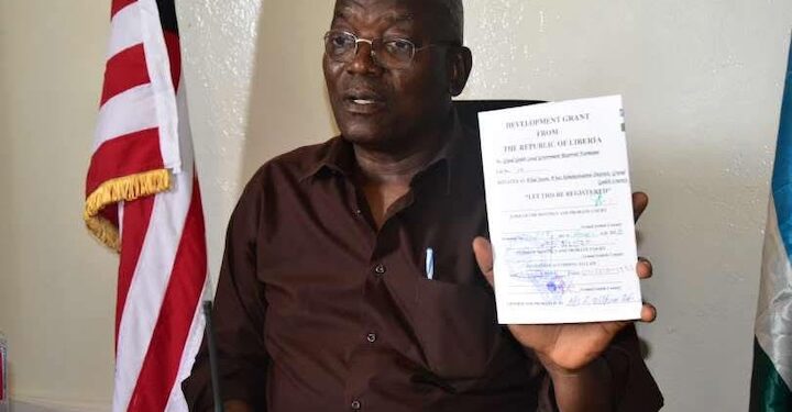 Grand Gedeh County officials and investor Boubou Sebu during the signing of a 30-year cocoa land lease agreement in Zwedru, Liberia.