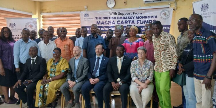 British Chargé d’Affaires Simon Tooth and Liberian justice advocates pose with civil society leaders at the launch of the Abolition of the Death Penalty Project in Monrovia.