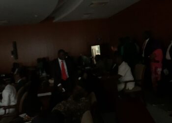 Lawmakers at Liberia’s Capitol Hill chamber sit in partial darkness during a 30-minute power outage as House Chair James Kolleh coordinates restoration efforts