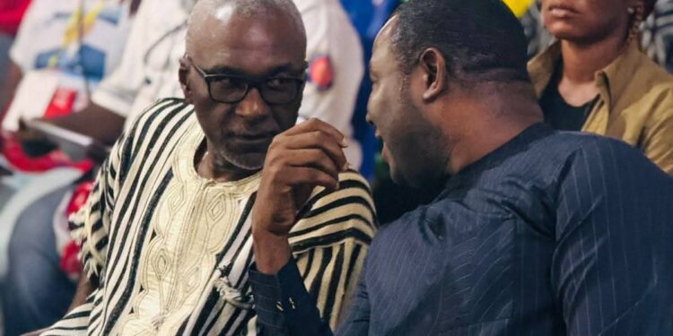 Unity Party Chairman Rev. Luther Tarpeh speaks with ANC Political Leader Alexander Cummings during the ANC National Convention in Margibi County, calling for political cooperation to support Liberia’s progress.