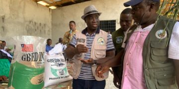 Liberian Agriculture Minister Dr. J. Alexander Nuetah unveils the Gbedin Rice brand and opens the 2025 national rice harvest in Sehyikepa, Nimba County, to boost local production and cut rice imports