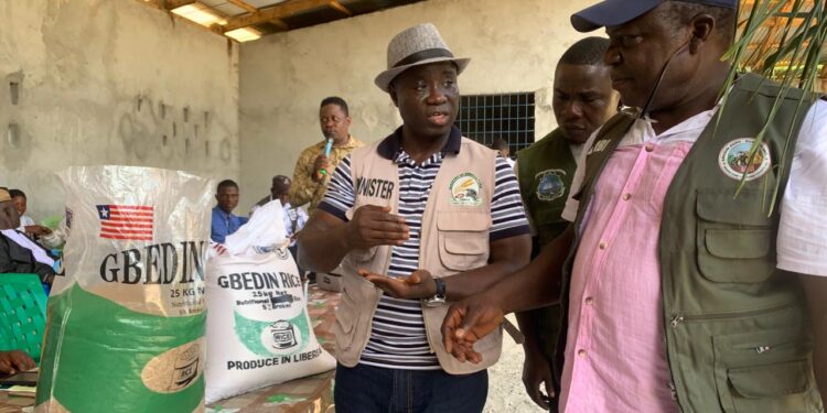 Liberian Agriculture Minister Dr. J. Alexander Nuetah unveils the Gbedin Rice brand and opens the 2025 national rice harvest in Sehyikepa, Nimba County, to boost local production and cut rice imports