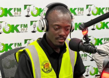 Labour rights advocate George S. Tengbeh of LILGA speaks during a radio interview after receiving death threats for exposing workplace abuses in Liberia