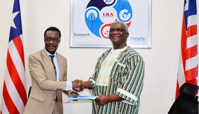 LSEZA Executive Chairman Prince Wreh and LRA Commissioner General James Dorbor Jallah shaking hands after signing a landmark MOU to boost trade, investment, and special economic zones in Liberia