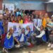 Members of the Paynesville Boulevard Omega Leos Club pose with community residents in West Point after a one-day mental health awareness campaign.
