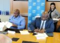 Finance Minister Augustine Kpehe Ngafuan and LEC Managing Director Mohammed M. Sherif sign a landmark solar power agreement with Scatec and IFC in Washington, D.C.