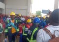 MVTC graduates in helmets and protective gear protesting during the 4th Circle Graduation in Monrovia over missing souvenirs and poor planning