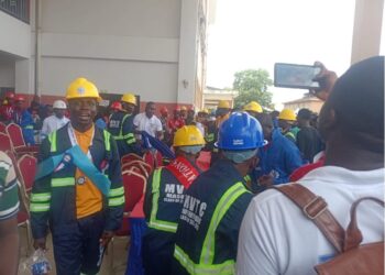MVTC graduates in helmets and protective gear protesting during the 4th Circle Graduation in Monrovia over missing souvenirs and poor planning
