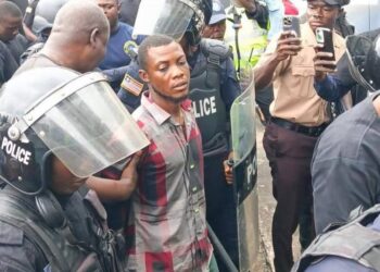 Commercial taxi driver Francis Nana escorted by police officers at the Monrovia City Court after being charged with murder for the death of LNP Patrolman Mark Bracewell at the Gabriel Tucker Bridge in Monrovia