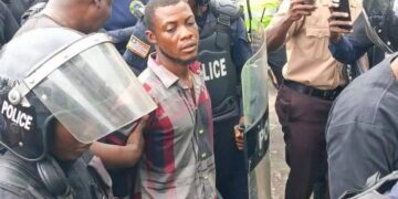 Commercial taxi driver Francis Nana escorted by police officers at the Monrovia City Court after being charged with murder for the death of LNP Patrolman Mark Bracewell at the Gabriel Tucker Bridge in Monrovia