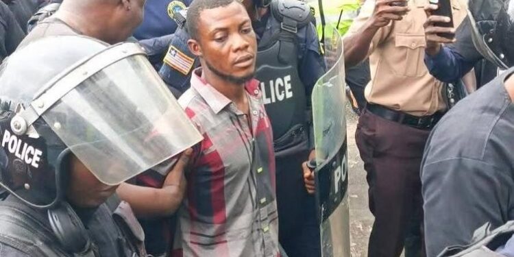 Commercial taxi driver Francis Nana escorted by police officers at the Monrovia City Court after being charged with murder for the death of LNP Patrolman Mark Bracewell at the Gabriel Tucker Bridge in Monrovia