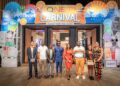 QNET executives and global distributors pose at the entrance of the V-Malaysia 2025 Carnival during the company’s 27th-anniversary convention in Penang, Malaysia.