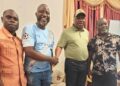 Liberia Vice President Jeremiah Koung standing and smiling as he greets supporters in Monrovia after returning from Ghana, dismissing speculation about his health