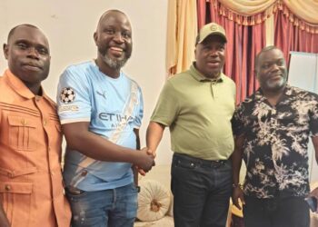 Liberia Vice President Jeremiah Koung standing and smiling as he greets supporters in Monrovia after returning from Ghana, dismissing speculation about his health