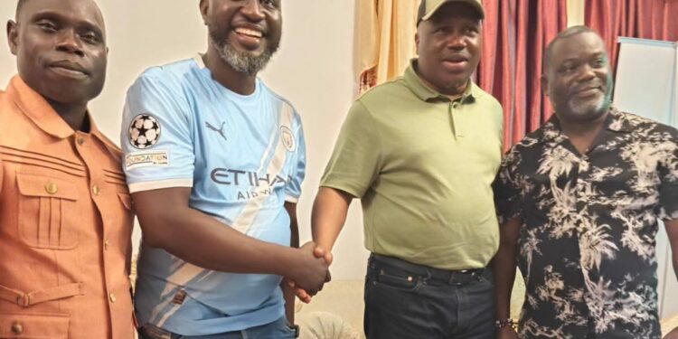 Liberia Vice President Jeremiah Koung standing and smiling as he greets supporters in Monrovia after returning from Ghana, dismissing speculation about his health