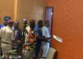 Sergeants-at-Arms escort Montserrado County District 10 Representative Yekeh Kolubah out of plenary following a heated exchange with Speaker Richard Koon at the Capitol.
