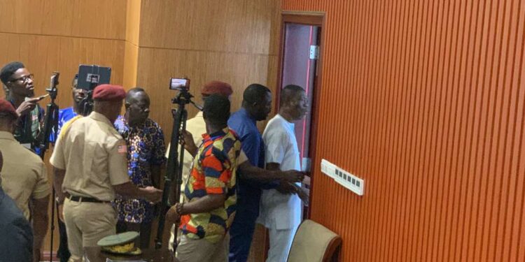 Sergeants-at-Arms escort Montserrado County District 10 Representative Yekeh Kolubah out of plenary following a heated exchange with Speaker Richard Koon at the Capitol.