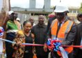 House Speaker Richard Nagbe Koon cuts a ribbon to dedicate the newly built $31,000 incinerator at JFK Medical Center in Monrovia, surrounded by officials and partners supporting the hospital’s waste management upgrade
