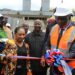 House Speaker Richard Nagbe Koon cuts a ribbon to dedicate the newly built $31,000 incinerator at JFK Medical Center in Monrovia, surrounded by officials and partners supporting the hospital’s waste management upgrade