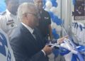 Indian Ambassador to Liberia Manoj Bihari Verma cuts the ribbon at the dedication of Bajaj Auto’s new Paynesville facility, alongside Silver Automobiles executives