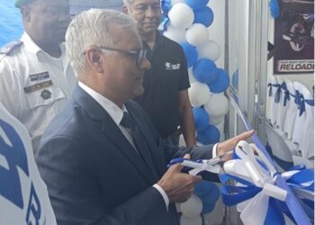 Indian Ambassador to Liberia Manoj Bihari Verma cuts the ribbon at the dedication of Bajaj Auto’s new Paynesville facility, alongside Silver Automobiles executives