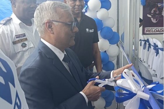 Indian Ambassador to Liberia Manoj Bihari Verma cuts the ribbon at the dedication of Bajaj Auto’s new Paynesville facility, alongside Silver Automobiles executives