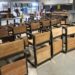 Rows of newly built wooden-and-metal classroom chairs at the Monrovia Vocational Training Center workshop, produced under the “One Chair, One Child” program funded by salaries withheld from suspended Liberian government officials