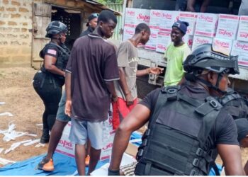 Liberia Drug Enforcement Agency officers search a businessman’s truck loaded with soap in Bernard’s Farm, Monrovia, after receiving a tip about possible narcotics