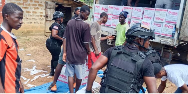 Liberia Drug Enforcement Agency officers search a businessman’s truck loaded with soap in Bernard’s Farm, Monrovia, after receiving a tip about possible narcotics