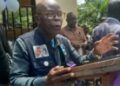 INCHR Chairperson Cllr. T. Dempster Brown speaks during the dedication of a memorial monument for war victims in Gbonyea, Bong County, calling out lawmakers for obstructing the war crimes court.