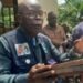 INCHR Chairperson Cllr. T. Dempster Brown speaks during the dedication of a memorial monument for war victims in Gbonyea, Bong County, calling out lawmakers for obstructing the war crimes court.