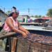 A Liberian woman fishmonger in Marshall, Margibi County, prepares smoked fish as part of a World Bank–funded empowerment project for coastal women traders