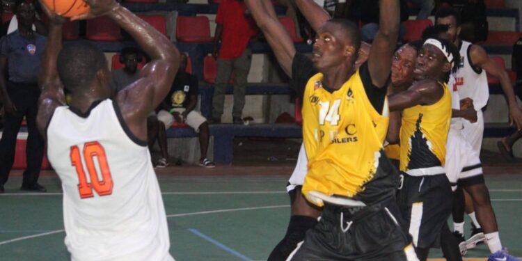 Mighty Barrolle’s forward attempts a jump shot as NPA Pythons defenders close in during their Liberia Basketball Association First Division semifinal series at SKD Gymnasium