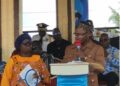 Margibi County Superintendent Ojay Morris delivers his speech at the UN@80 celebration in Kakata as President Joseph N. Boakai and UN officials look on