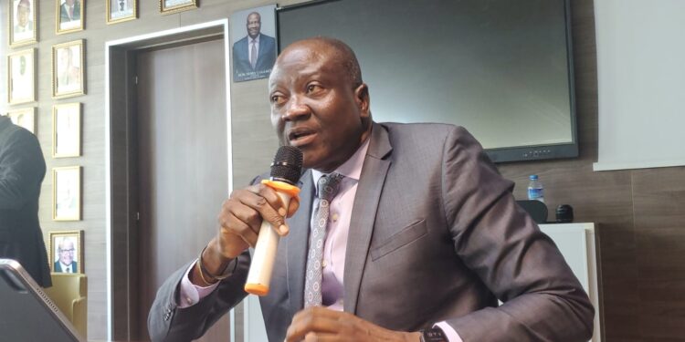 Central Bank of Liberia Executive Governor Henry Saamoi addresses a press conference in Monrovia after announcing a one-point cut in the monetary policy rate.