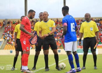 Liberia and Equatorial Guinea captains exchange flags before kickoff at the Estadio de Malabo during their final 2026 World Cup qualifying match
