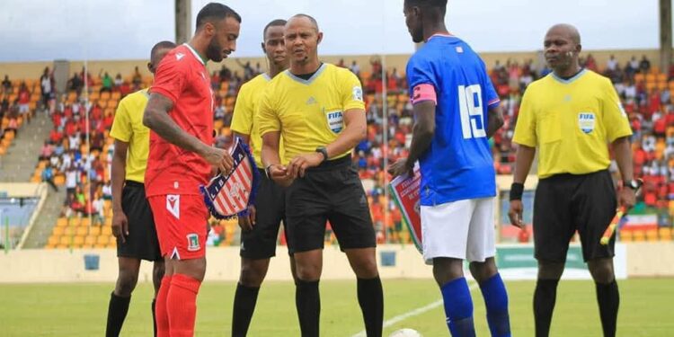 Liberia and Equatorial Guinea captains exchange flags before kickoff at the Estadio de Malabo during their final 2026 World Cup qualifying match