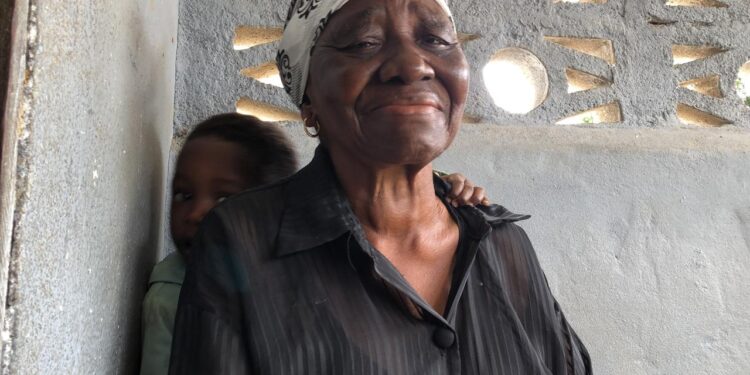 An elderly woman weeps as residents of the Hotel Africa community in Lower Virginia face mass eviction under a government land reclamation order