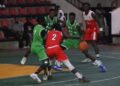 Oilers guard drives past Pythons defenders during Game 1 of the Liberia Basketball Association First Division Finals