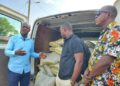 Community leaders of the New Kru Town Jamboree receive 100 bags of cement donated by U.S.-based Liberian Richard Wah Sio to support the Trowin–Mombo Bridge Project