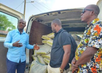 Community leaders of the New Kru Town Jamboree receive 100 bags of cement donated by U.S.-based Liberian Richard Wah Sio to support the Trowin–Mombo Bridge Project