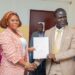 EPA Executive Director Dr. Emmanuel Urey Yarkpawolo and Project Lead Vermon Sangah Lloyd exchange documents during the signing of a waste management MOU in Monrovia