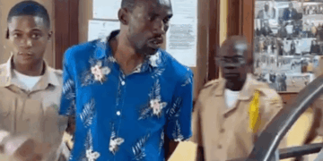 Pastor Jenkins Johnson escorted by officers after his arrest at Monrovia City Court