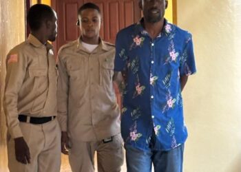 Pastor Jenkins Johnson escorted by court officers at the Temple of Justice amid allegations of impregnating a congregant’s wife in Liberia.