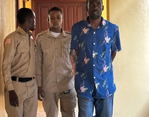 Pastor Jenkins Johnson escorted by court officers at the Temple of Justice amid allegations of impregnating a congregant’s wife in Liberia.