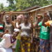 Rural women in Western Liberia raise their hands in solidarity during a community meeting, calling on President Joseph Boakai for financial empowerment and market support